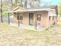 Charming one-story home featuring a covered front porch with seating area and an ADT security system at 313 Springwood Dr, Walterboro, SC 29488