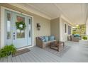 Inviting front porch with cozy seating, stylish decor, and a welcoming entrance, perfect for relaxing or entertaining guests at 3204 Waterway Blvd, Isle of Palms, SC 29451