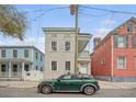 Classic two-story home with inviting double porches, neutral siding, and traditional details in a bustling city area at 40 Pitt St, Charleston, SC 29401