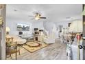 Bright living room with wood floors, ceiling fan, modern furniture, and entertainment center at 402 Pine Bluff Dr, Summerville, SC 29483