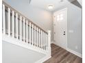Bright entryway featuring hardwood floors, a white staircase, and natural light at 413 Renau Blvd, Summerville, SC 29483