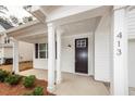 Inviting front porch with classic columns and a dark wood front door at 413 at 413 Renau Blvd, Summerville, SC 29483