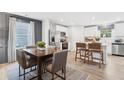 A dining room and kitchen area showcasing stainless steel appliances and natural light at 4183 Rising Tide Dr, Summerville, SC 29485