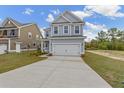 Two-story home with a manicured lawn and attached two car garage at 707 Alma Square Dr, Moncks Corner, SC 29461