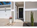 Inviting front entrance with decorative wreath and a pot of flowers, leading to a two-car garage at 749 Jancus St, Charleston, SC 29414
