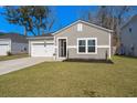 Lovely one-story home featuring a well-maintained lawn and an attached two-car garage at 749 Jancus St, Charleston, SC 29414