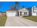 Beautiful one-story home featuring a well-maintained lawn and an attached two-car garage at 749 Jancus St, Charleston, SC 29414