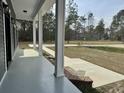 Spacious front porch with white columns, brick steps, and a view of the expansive front yard at 85 Prestwick Pl, Walterboro, SC 29488
