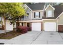 Inviting exterior of a townhome, showcasing blooming bushes, a driveway, and a single-car garage at 8741 Grassy Oak Trl, North Charleston, SC 29420