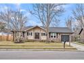 Charming house with brick accents, mature trees, well-manicured lawn, and inviting front porch at 914 Aleppo Dr, Ladson, SC 29456
