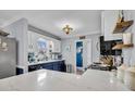 Bright, modern kitchen with white cabinets, navy blue lower cabinets, stainless appliances, and marble countertops at 914 Aleppo Dr, Ladson, SC 29456