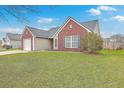 Well-maintained home boasting a lush front lawn, attached garage, and classic brick and siding at 99 Dovetail Cir, Summerville, SC 29483