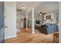 Bright living room featuring hardwood floors, a fireplace, and elegant columns at 1032 Black Rush Cir, Mount Pleasant, SC 29466