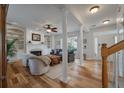 Open-concept living room with hardwood floors, fireplace, and staircase at 1032 Black Rush Cir, Mount Pleasant, SC 29466