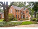 Beautiful two-story brick home with a well-manicured lawn and mature trees at 1278 Deep Water Dr, Mount Pleasant, SC 29464
