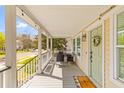 Inviting covered front porch with seating, decorative plants, and a view of the neighborhood at 1322 Addykay Pl, North Charleston, SC 29406