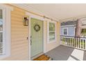 Charming porch with welcome mat, wreath and outdoor lighting at 1322 Addykay Pl, North Charleston, SC 29406