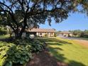 Charming home with lush landscaping, large trees, and a separate garage at 1420 Polly Point Rd, Wadmalaw Island, SC 29487