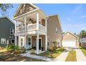 Inviting exterior showcasing a well-maintained home with a double porch and attached garage at 1532 Roustabout Way, Charleston, SC 29414