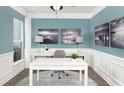 Comfortable home office with wainscoting, natural light, and monochromatic decor for a refined look at 163 Royal Cainhoy Way, Huger, SC 29450