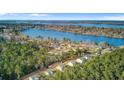 Scenic aerial view of a residential neighborhood nestled beside a tranquil lake and dense trees at 1633 Pimlico Blvd, Moncks Corner, SC 29461