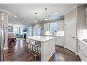 Open concept kitchen features a large island with seating, white cabinets, and stainless steel appliances at 1644 Fishbone Dr, Johns Island, SC 29455