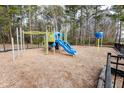 Community playground featuring colorful slides, climbing structures, and a safety-conscious wood chip ground cover within fenced area at 173 Cypress Forest Dr, Moncks Corner, SC 29461