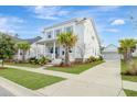 Beautiful two-story home with well-maintained lawn, palm trees, and a detached garage at 1756 Timmons St, Mount Pleasant, SC 29466