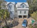 View of the exterior featuring the home's light colored siding and staircase at 18 Wills Way, Isle of Palms, SC 29451