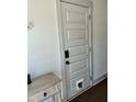 Hallway with white door that has a pet door and modern baseboard and door frame trim detail at 1818 Orangeburg St, North Charleston, SC 29405