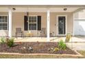 Inviting front porch with seating area, decorative plants, and charming decor elements at 215 Trickle Dr, Summerville, SC 29483