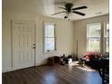 Bright living room featuring wood floors, ceiling fan, and natural light from two windows at 2326 Kent Ave, North Charleston, SC 29405
