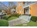 Lovely yellow home with an inviting entrance, green lawn, and well-maintained landscaping at 234 Rutledge Ave # C, Charleston, SC 29403