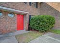 View of the brick exterior and bright red front door at 2362 Parsonage Rd # 2G, Charleston, SC 29414