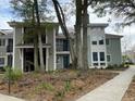 Two-story condos featuring charming balconies and a sidewalk, set amidst mature trees and landscaping at 276 Alexandra Dr # 6, Mount Pleasant, SC 29464