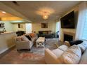 Inviting living room featuring a fireplace, neutral-colored furniture and modern lighting fixtures at 276 Alexandra Dr # 6, Mount Pleasant, SC 29464