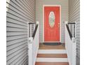 Close-up of a bright red front door with decorative glass and white trim at 3518 Gatetree Rd, Johns Island, SC 29455