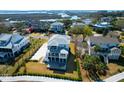 Stunning aerial view showcases the coastal neighborhood with lush green lawns and beautiful marsh views at 4176 Victory Pointe Dr, Mount Pleasant, SC 29466