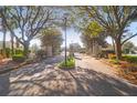 Elegant gated community entrance with mature trees and landscaping welcomes residents and guests at 4176 Victory Pointe Dr, Mount Pleasant, SC 29466