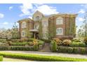 Grand two-story home featuring a brick facade, manicured landscaping, and a welcoming entrance with a stairway and brick walkway at 4202 Links Ct, North Charleston, SC 29420