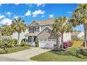 Beautifully landscaped home with a two-car garage and charming curb appeal at 422 Sanders Farm Ln, Charleston, SC 29492
