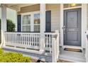 Inviting front porch with white railing and a charming door with an anchor accent at 422 Sanders Farm Ln, Charleston, SC 29492