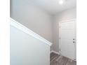 Bright entryway featuring wood-look floors, white trim, and a white door leading to the garage at 522 Truman Dr, Goose Creek, SC 29445