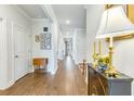 Inviting hallway with hardwood floors, neutral walls and decorative accents at 532 Fern Tree Dr, Summerville, SC 29486