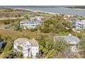 Stunning aerial view overlooking a beautiful home, lush vegetation, and gorgeous waterfront views at 65 Ocean Point Dr, Isle of Palms, SC 29451