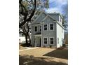 Charming two-story home with new paint, black trim windows, and a beautiful mature tree at 651 Magnolia Rd, Charleston, SC 29407