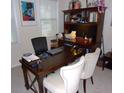 Bright office space with a large wooden desk and ample storage, perfect for remote work at 8592 Sentry Cir, North Charleston, SC 29420