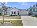 Charming single-Gathering home with a well-manicured lawn and a covered front porch at 87 Morning Song St, Summerville, SC 29485