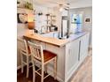 Charming kitchen with butcher block countertops, white cabinets, floating shelves, and updated appliances at 927 Dills Bluff Rd # 33, Charleston, SC 29412