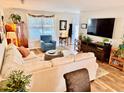 Bright living room with a cozy sectional, TV, wood floors, and decorative plants for a welcoming space at 927 Dills Bluff Rd # 33, Charleston, SC 29412